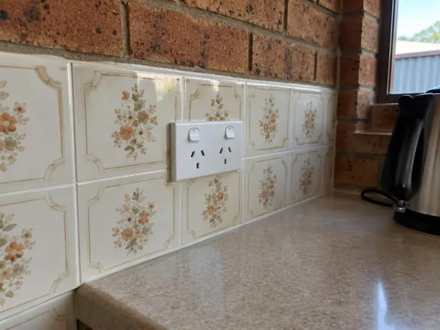 Double power point on a tiled kitchen splashback above a laminate bench in Warnervale